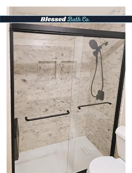 Stone-look shower walls with matte black fixtures, grab bar and niche