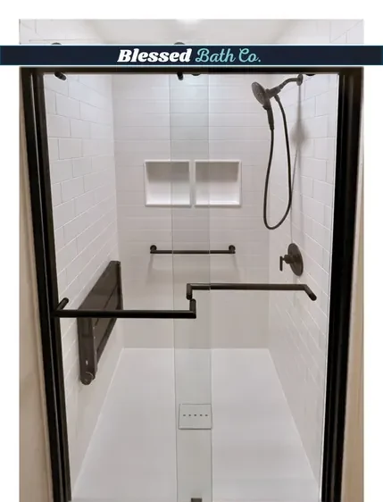 Matte black framed glass shower door with a double niche and black grab bar