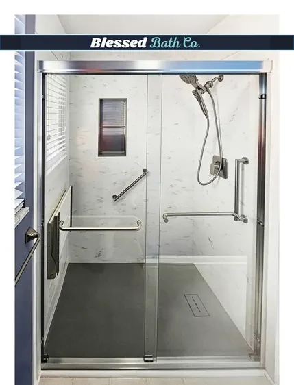 Walk-in shower with a black-framed sliding glass door, recessed niche and handheld showerhead