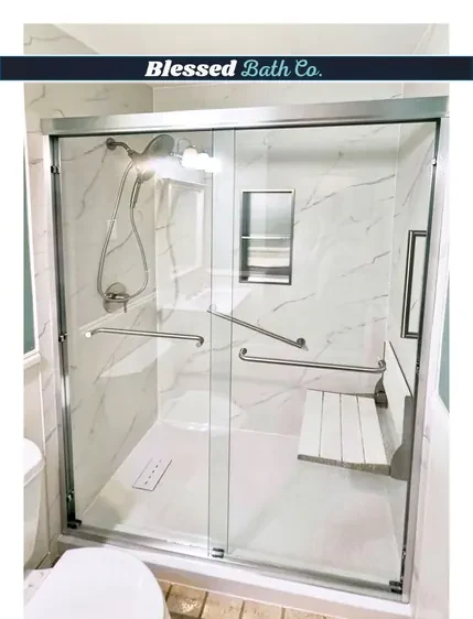 Walk-in shower with a glass door, fold-down seat and recessed niche