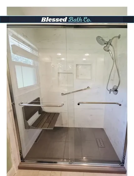 Walk-in shower with a glass sliding door, fold-down seat and brushed nickel fixtures