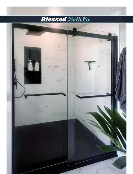 Walk-in shower with a matte black sliding door, recessed niche and dark shower base